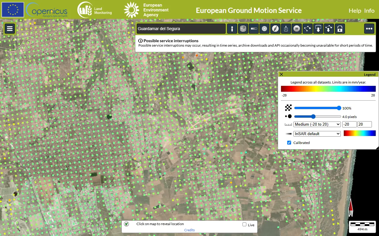 The 100 m grid of coloured dots over Guardamar del Segura in the EGMS viewer, with the legend from -20 to +20 mm/year